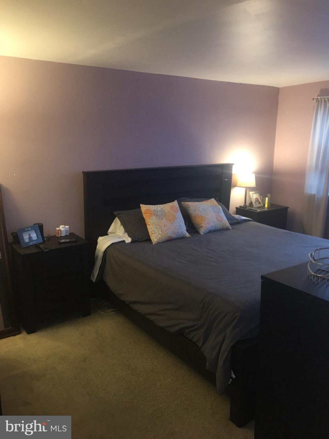 1728 Ingram Road Baltimore, MD 21239 - Photo 17 of 44 a bedroom with a bed and a night stand
