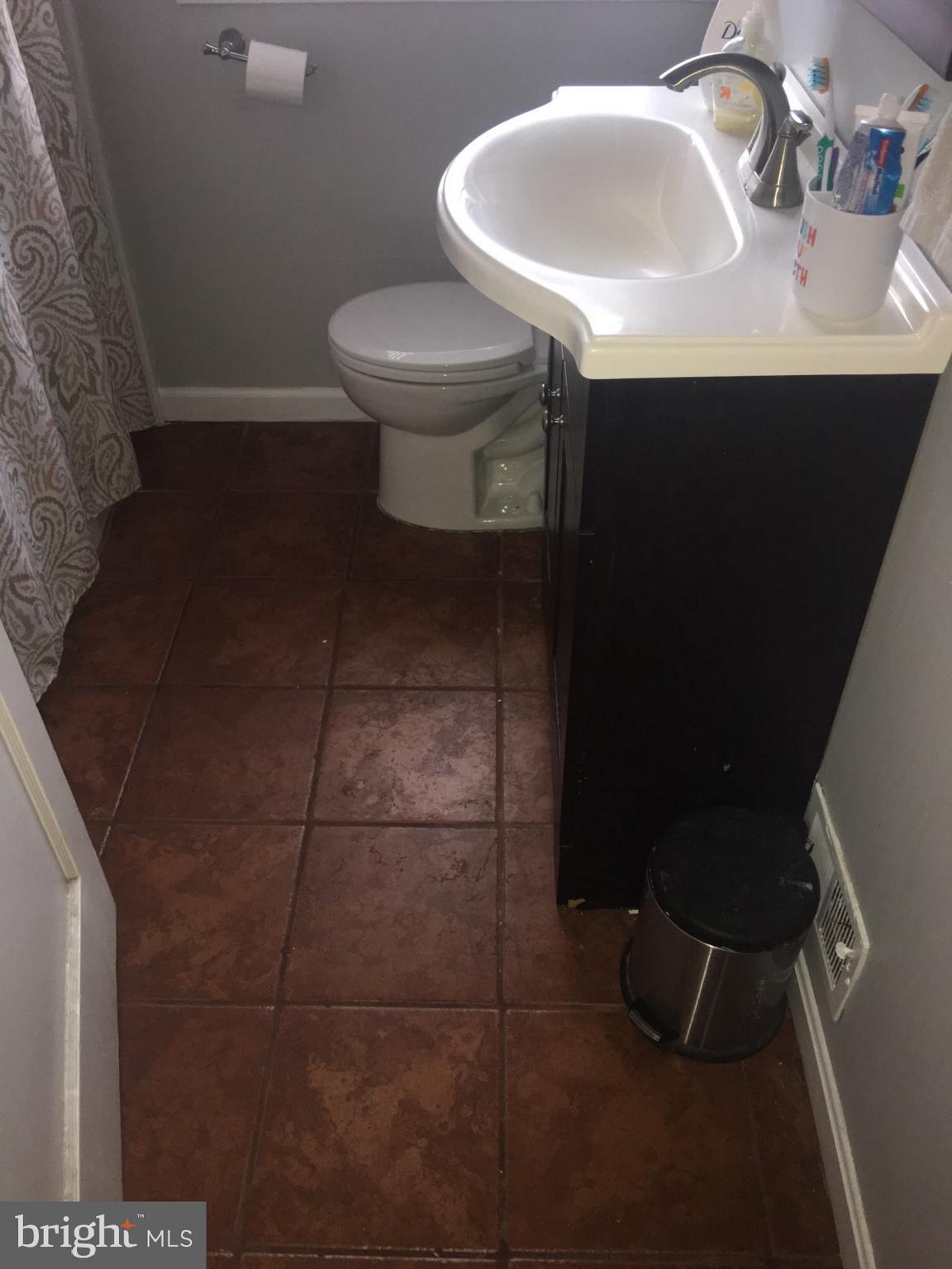 1728 Ingram Road Baltimore, MD 21239 - Photo 20 of 44 a bathroom with a sink toilet and mirror