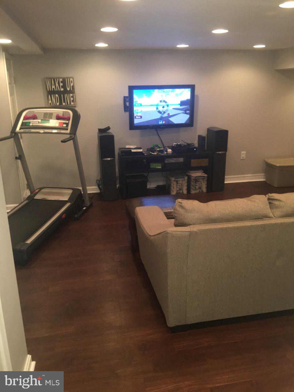 1728 Ingram Road Baltimore, MD 21239 - Photo 29 of 44 a living room with furniture and a flat screen tv
