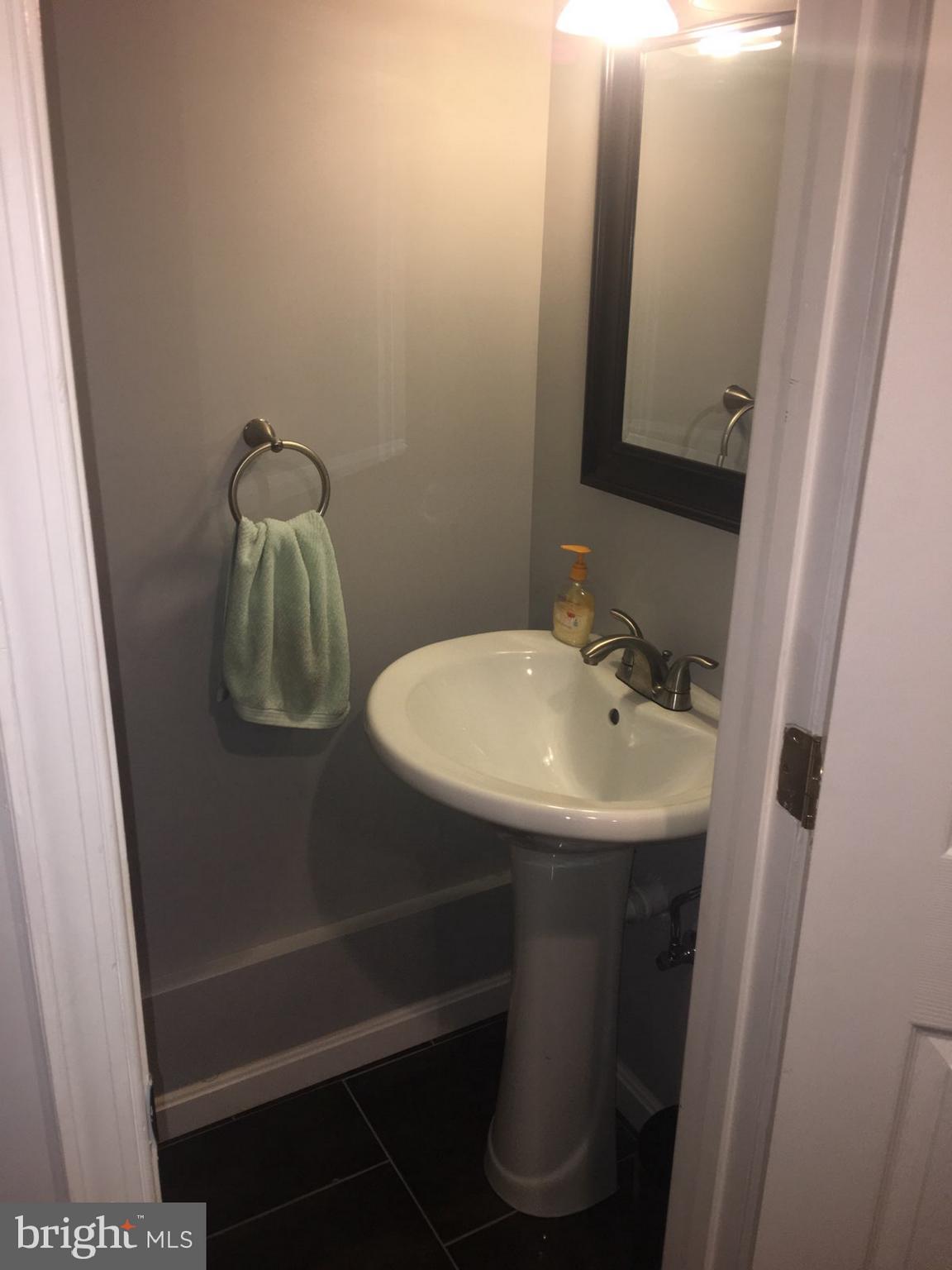 1728 Ingram Road Baltimore, MD 21239 - Photo 33 of 44 a bathroom with a sink and mirror