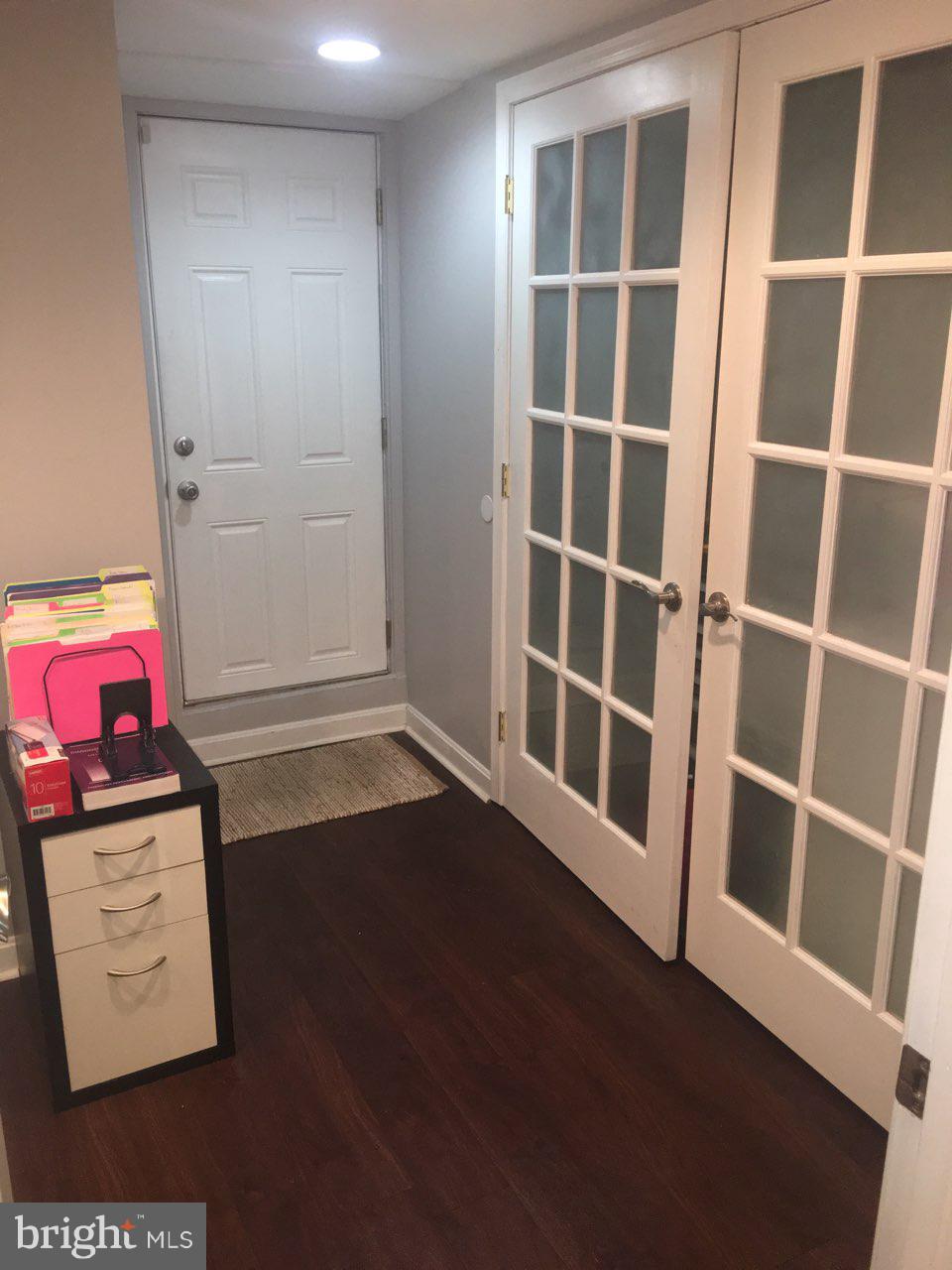 1728 Ingram Road Baltimore, MD 21239 - Photo 35 of 44 a view of an empty room with wooden floor and a window