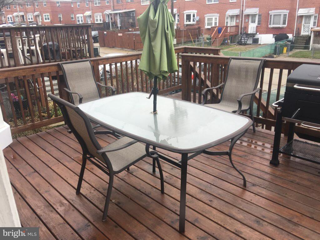 1728 Ingram Road Baltimore, MD 21239 - Photo 43 of 44 a view of a balcony with two chairs and wooden floor