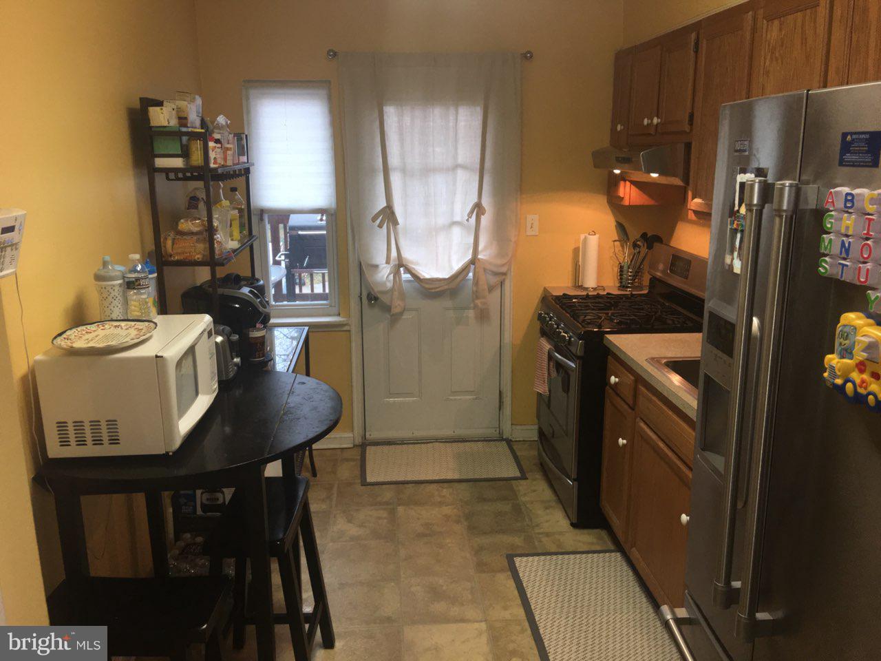 1728 Ingram Road Baltimore, MD 21239 - Photo 9 of 44 a kitchen with stainless steel appliances granite countertop a sink a stove and a refrigerator