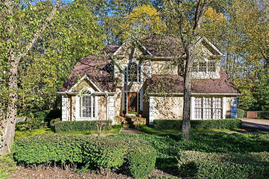Elegant family home with side entry garage, hard-coat stucco, many windows!  