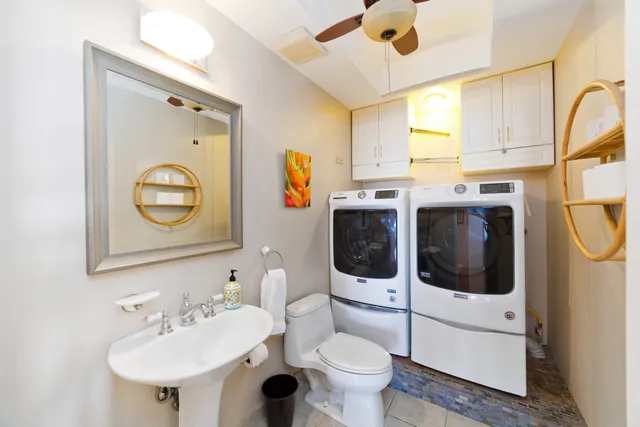 a bathroom with a toilet sink and mirror