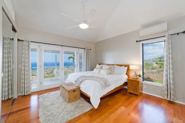 a bedroom with a large bed and a large window