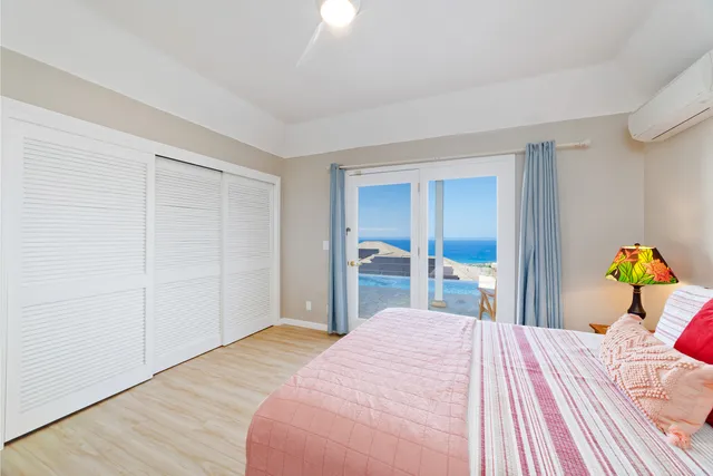 a bedroom with a bed and a large mirror