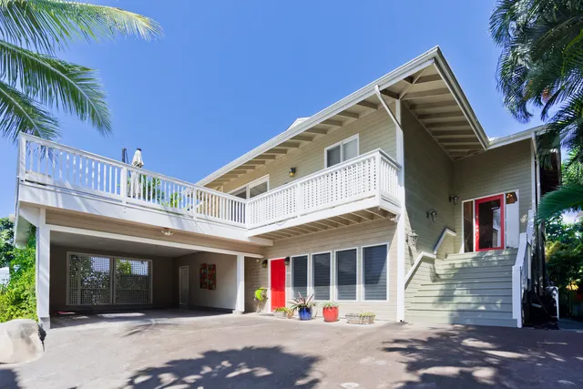 a front view of a building with palm tree