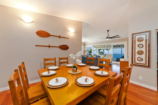 a dining room with furniture and wooden floor