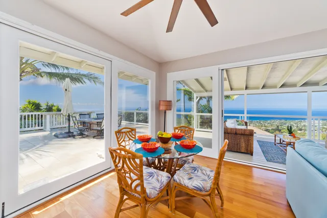 a living room with patio furniture and a floor to ceiling window
