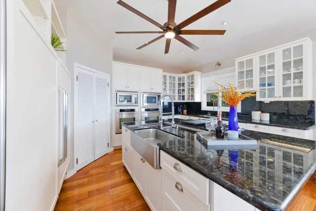 a kitchen with stainless steel appliances granite countertop a stove and cabinets
