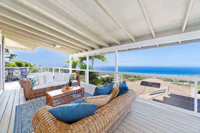 a balcony with couch and chairs