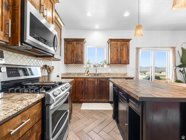 256 West Horizon Loop Payson, UT 84651 - Photo 9 of 33 Kitchen featuring wooden counters, stainless steel appliances, decorative light fixtures, parquet floors, and decorative backsplash
