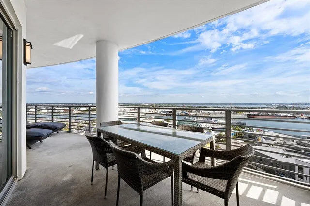 a view of a balcony with furniture and a floor to ceiling window