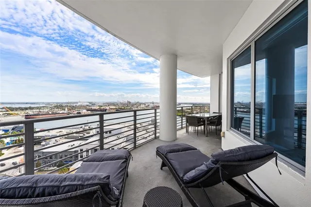a bedroom with a large window and a flat screen tv