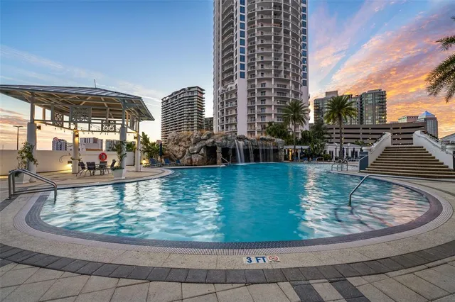 a swimming pool with outdoor seating and yard