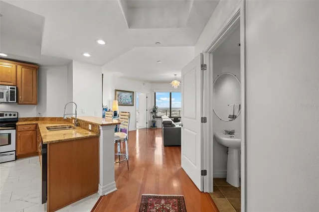 a kitchen with granite countertop a refrigerator and a sink
