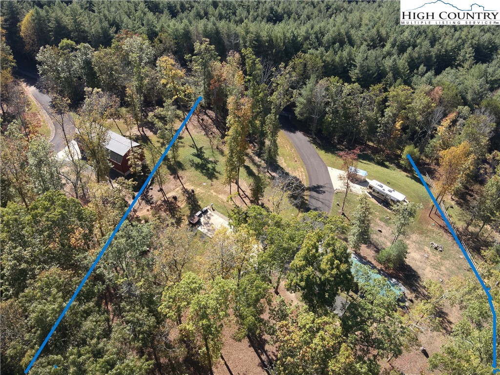 2380 Mt Carmel Road Sparta, NC 28675 - Photo 10 of 12 an aerial view of a house with a yard and covered with trees