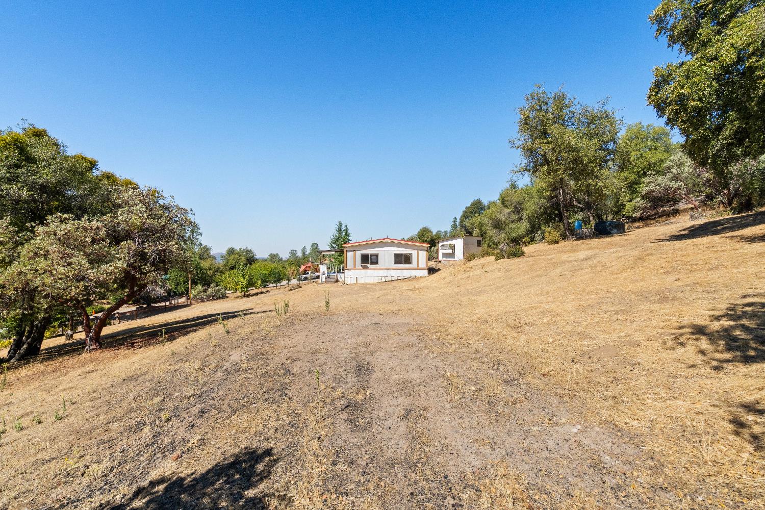 40882 Jean Road East Oakhurst, CA 93644 - Photo 13 of 32 a view of the road with a building in the background