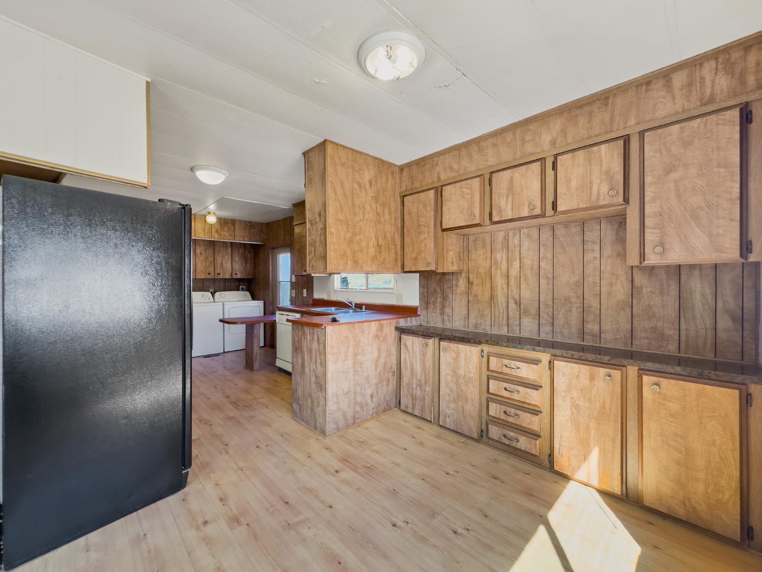 40882 Jean Road East Oakhurst, CA 93644 - Photo 24 of 32 a kitchen with cabinets and wooden floor