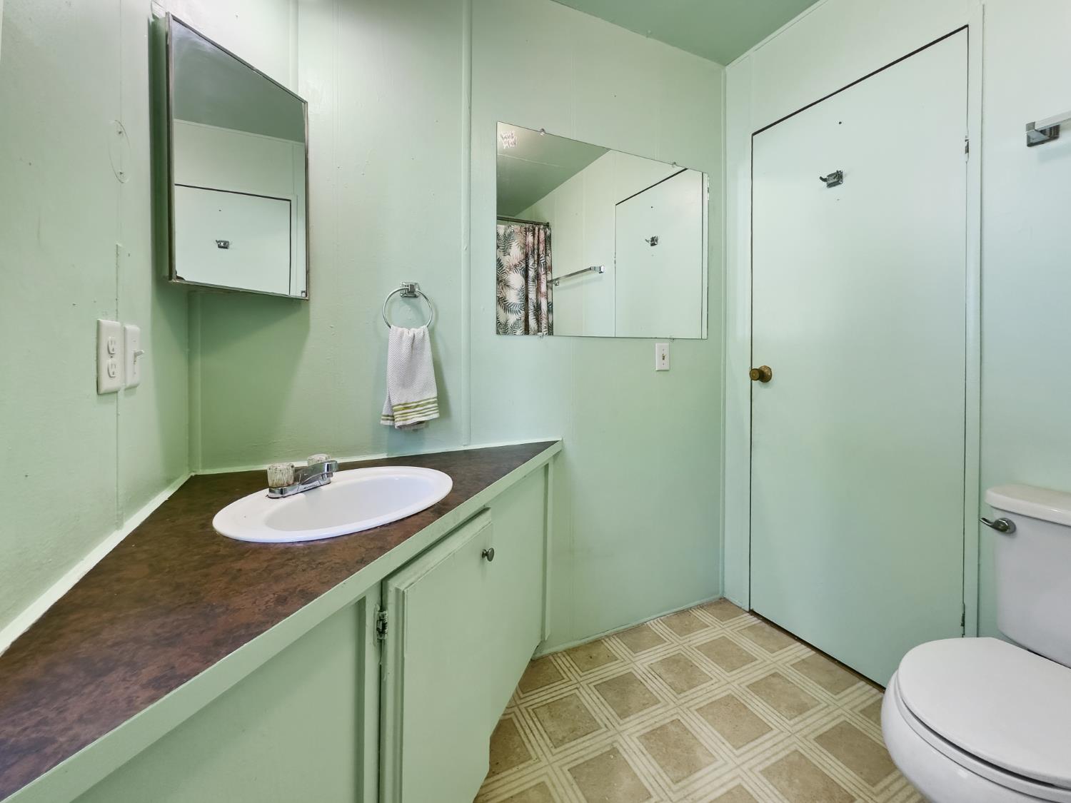 40882 Jean Road East Oakhurst, CA 93644 - Photo 29 of 32 a bathroom with a granite countertop sink and a mirror