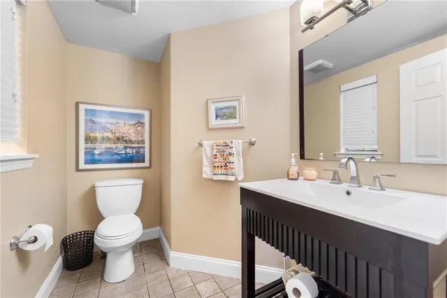 a bathroom with a toilet a sink and mirror