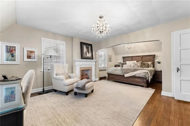 a bedroom with furniture and a fireplace