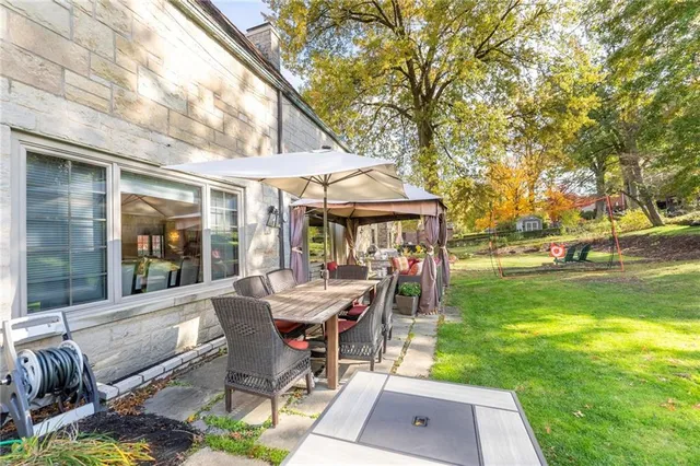 a view of a house with a big yard and potted plants