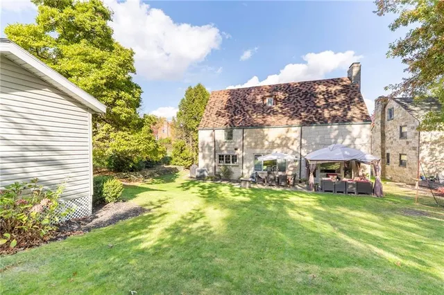 a view of a house with backyard porch and sitting area