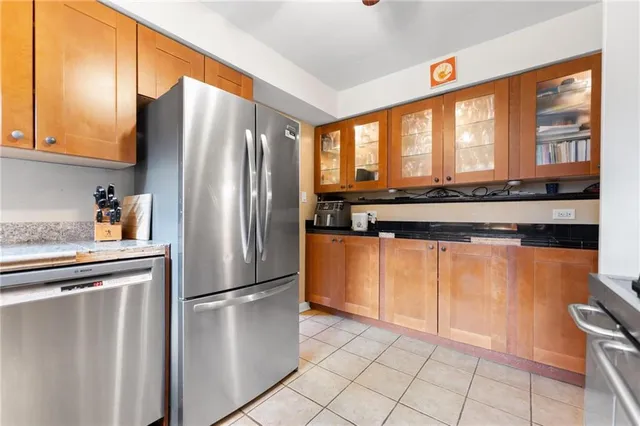 a kitchen with stainless steel appliances granite countertop a refrigerator and a sink