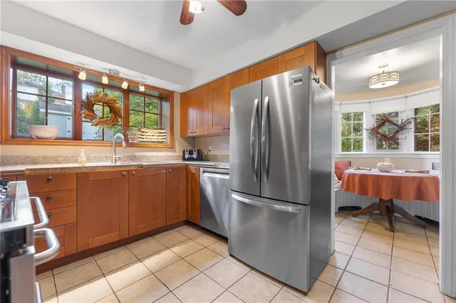 a kitchen with stainless steel appliances granite countertop a refrigerator and a sink