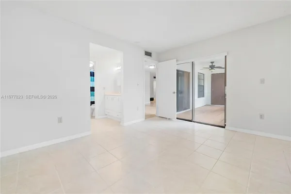 a view of a big room with entryway and white walls