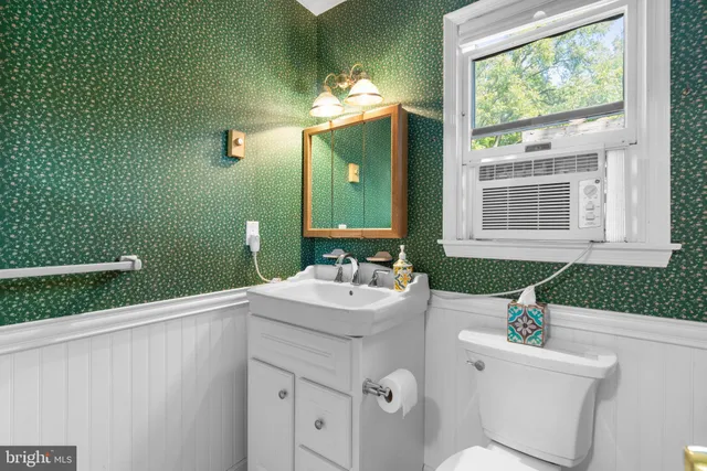 a bathroom with a sink mirror and window