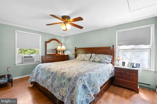 a bedroom with a bed and a large window