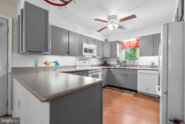 a kitchen with granite countertop a sink cabinets and window