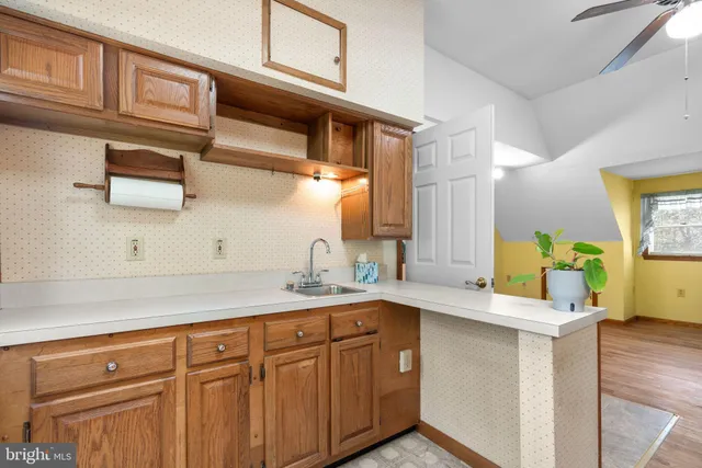 a kitchen with a sink cabinets and a wooden floor