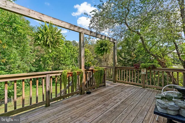 a view of balcony with wooden floor and fence