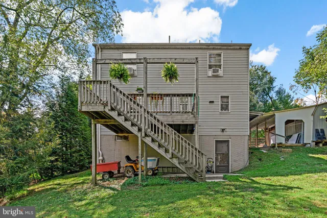 a view of a house with a yard and deck