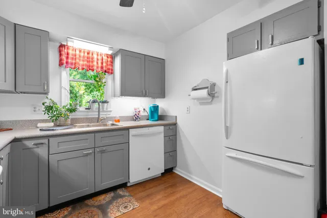 a kitchen with a refrigerator and window