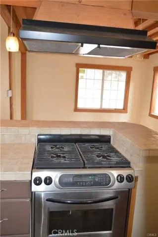 a stove top oven sitting inside of a kitchen