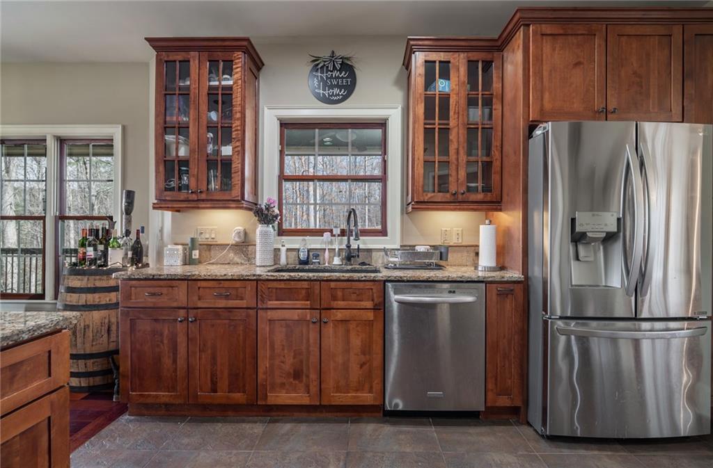723 Sulphur Springs Road Southeast Fairmount, GA 30139 - Photo 14 of 54 a kitchen with stainless steel appliances granite countertop a refrigerator and a stove