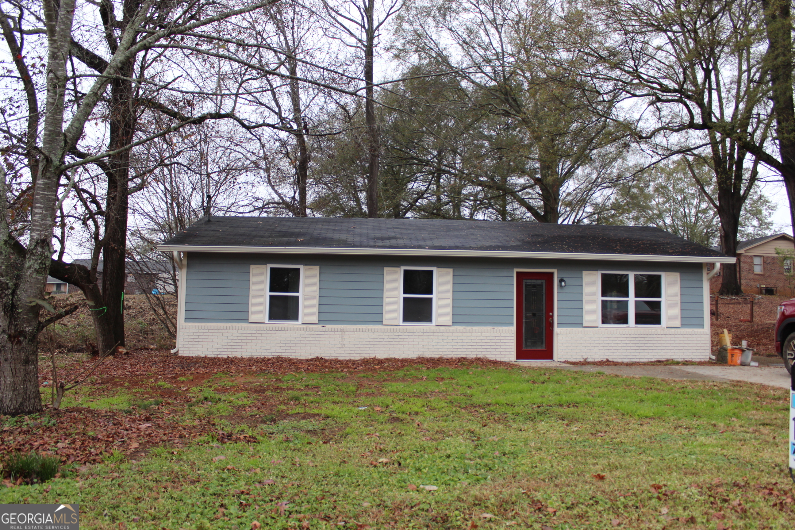a front view of house with yard and trees