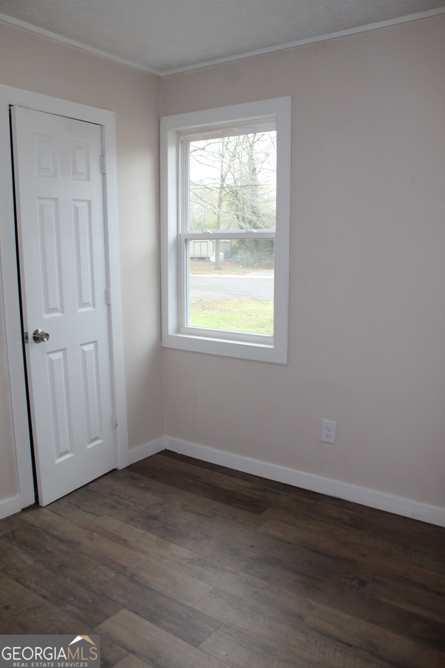 21 Duke Circle Winder, GA 30680 - Photo 14 of 19 an empty room with wooden floor and windows