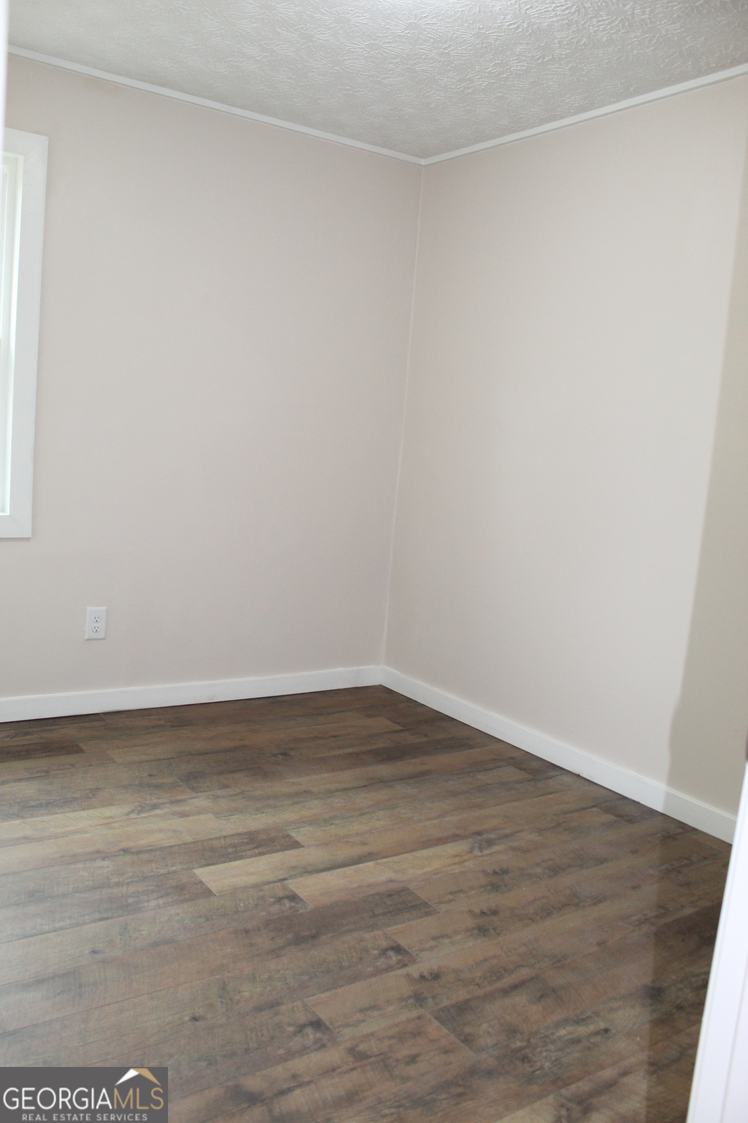 21 Duke Circle Winder, GA 30680 - Photo 15 of 19 a view of an empty room with wooden floor and a window