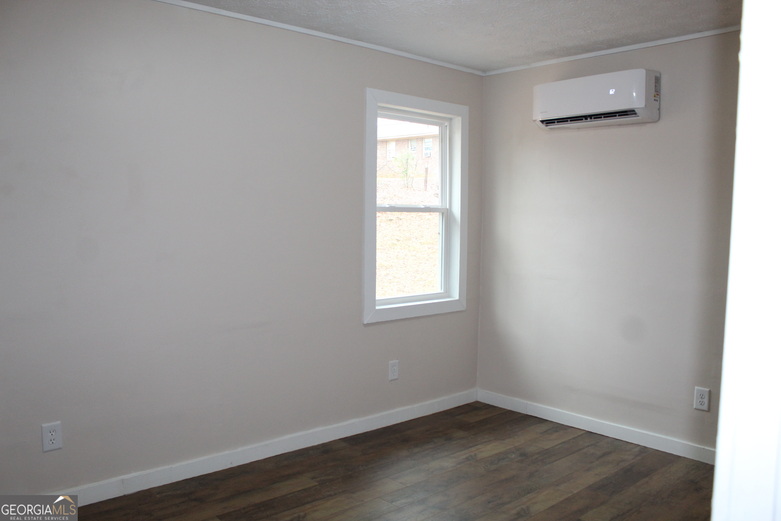 21 Duke Circle Winder, GA 30680 - Photo 16 of 19 an empty room with wooden floor and windows