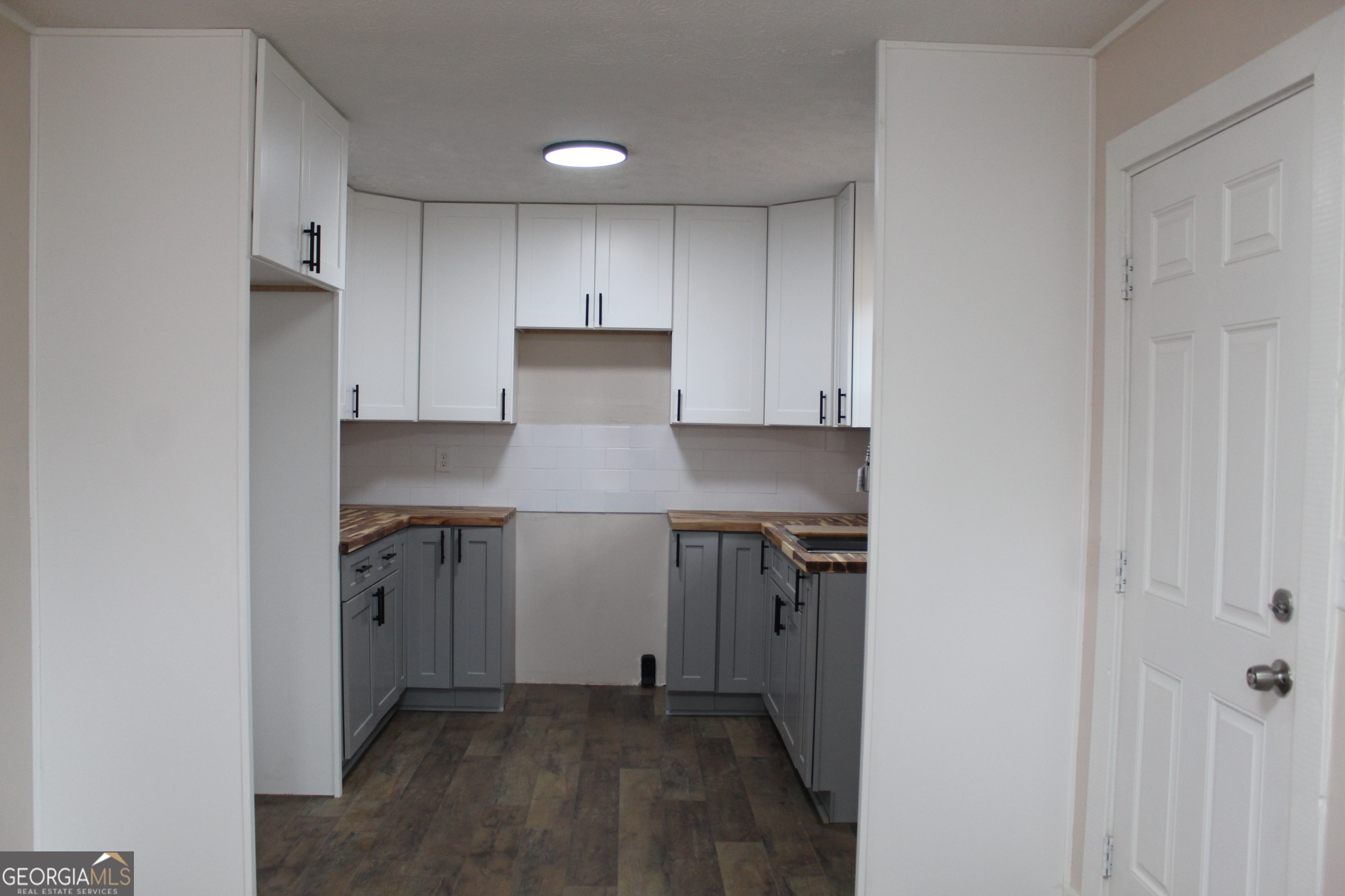 21 Duke Circle Winder, GA 30680 - Photo 5 of 19 a kitchen with a refrigerator and white cabinets