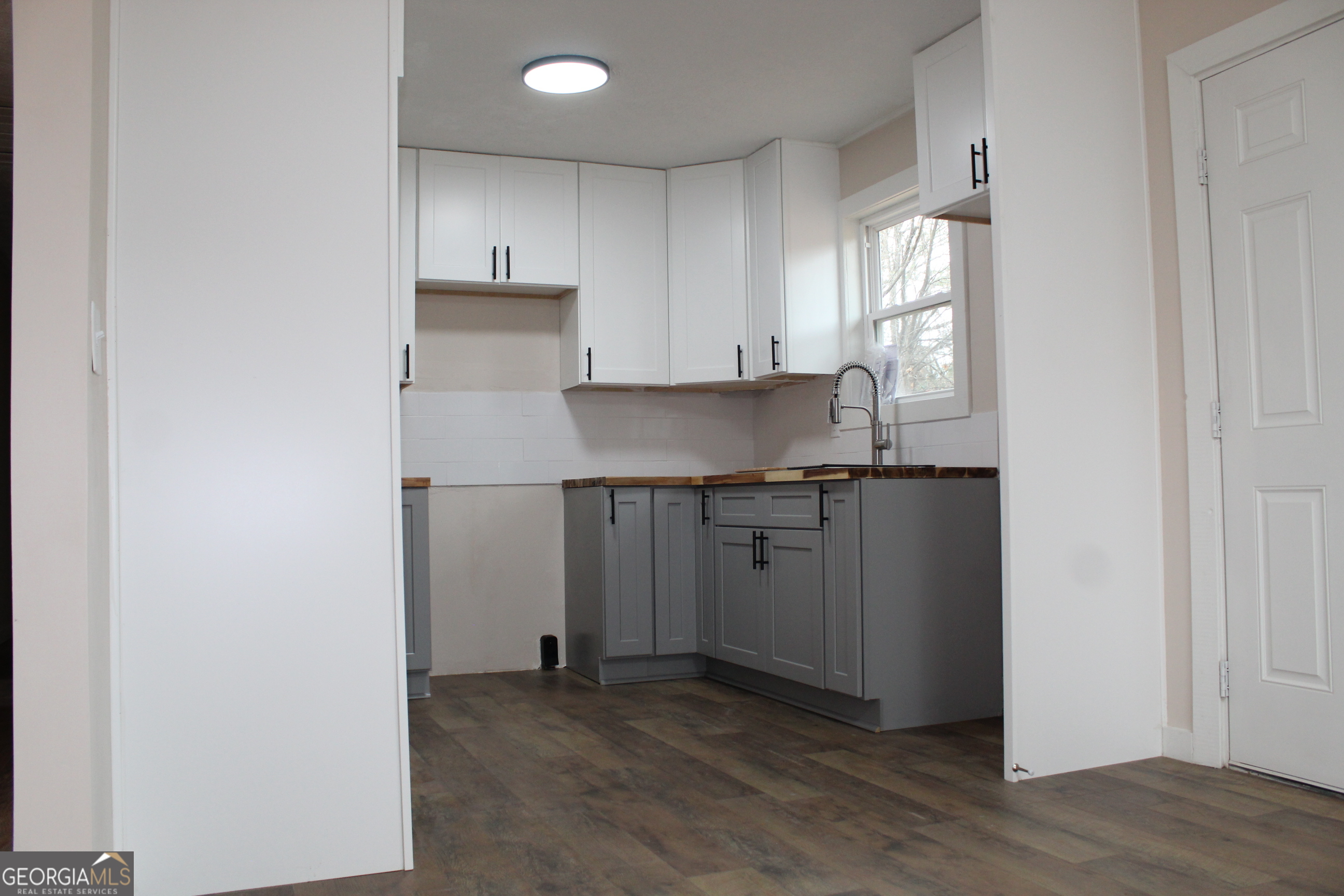 21 Duke Circle Winder, GA 30680 - Photo 7 of 19 a kitchen with kitchen island granite countertop white cabinets and stainless steel appliances