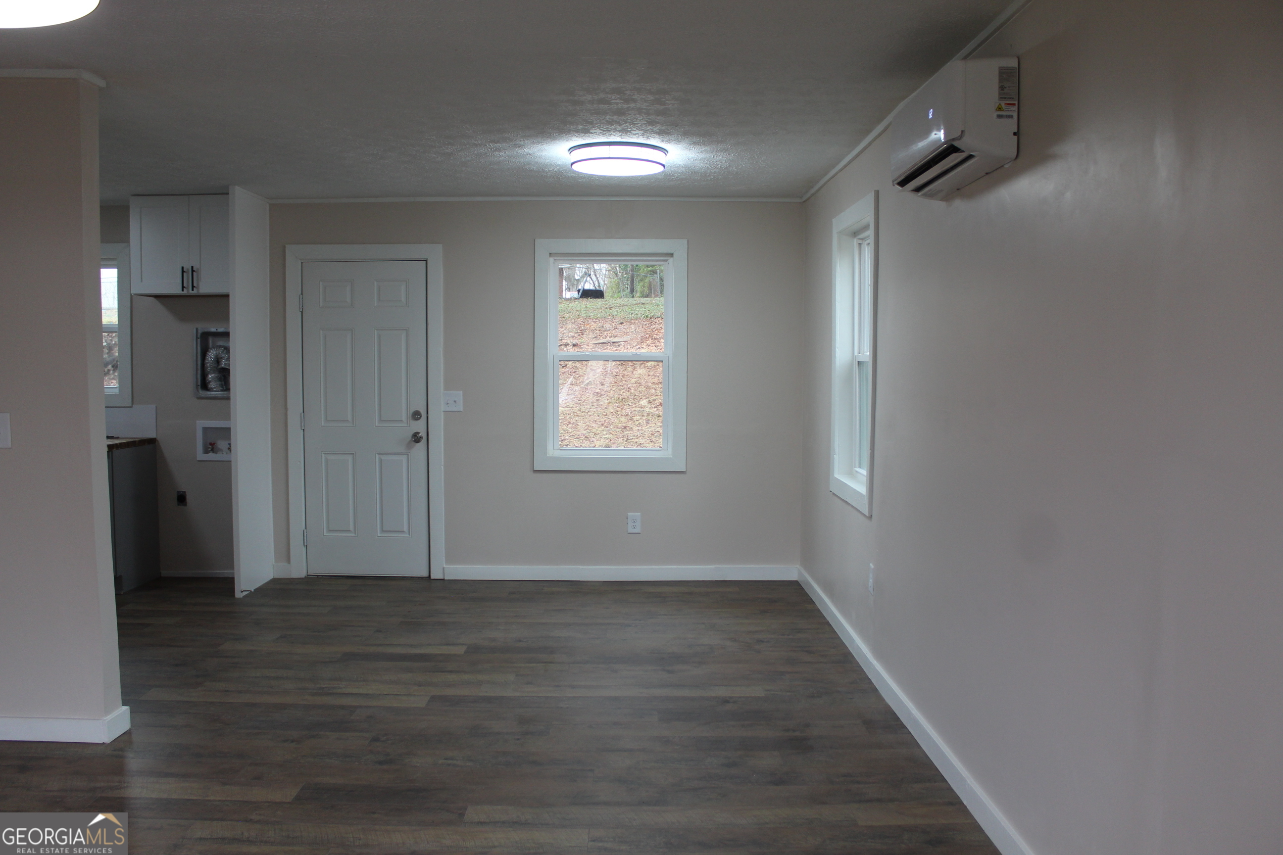 21 Duke Circle Winder, GA 30680 - Photo 8 of 19 a view of an empty room with wooden floor and a window