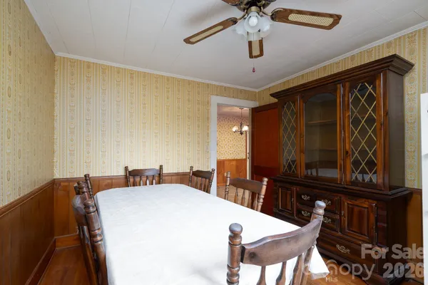 a view of a dining room with furniture and chandelier
