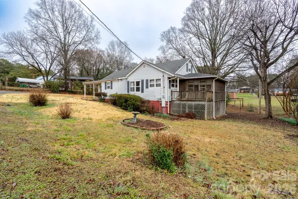 a view of a house with a yard covered with snow